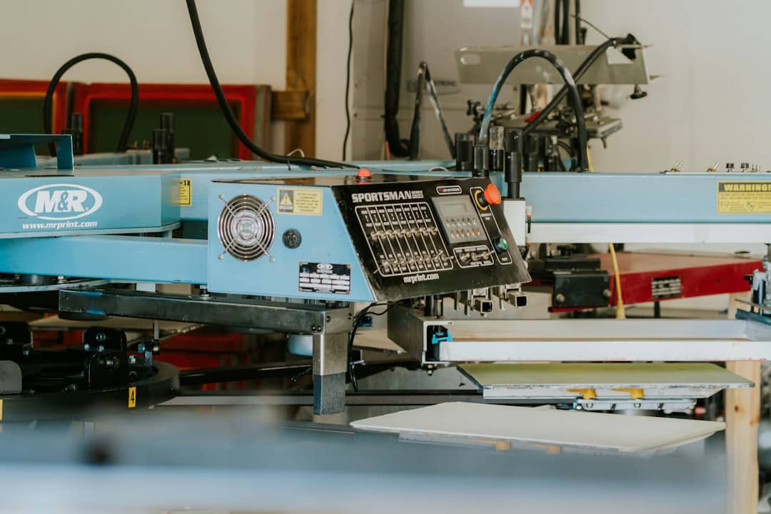 Industrial screen printing machine in a workshop setting